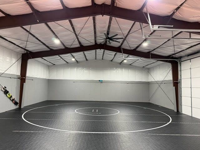 Clear-span steel wrestling gym interior with a full competition mat in Spring Creek, Nevada